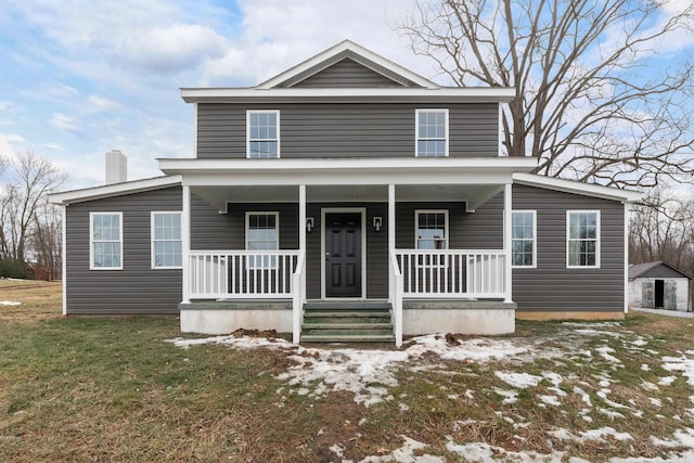 view of front of home with a chimney, a porch, and a front yard