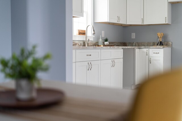 kitchen with white cabinetry and a sink