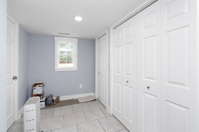 bedroom with visible vents, baseboards, and light tile patterned floors