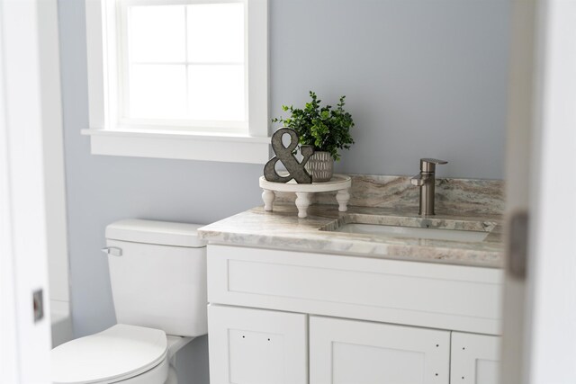 bathroom featuring toilet and vanity