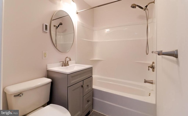 bathroom featuring vanity, toilet, and washtub / shower combination