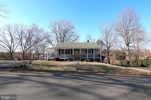 view of front of property with covered porch and a chimney