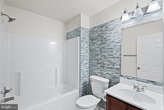 full bathroom featuring bathtub / shower combination, toilet, tile walls, and vanity