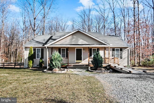 view of front of home featuring covered porch and a front lawn