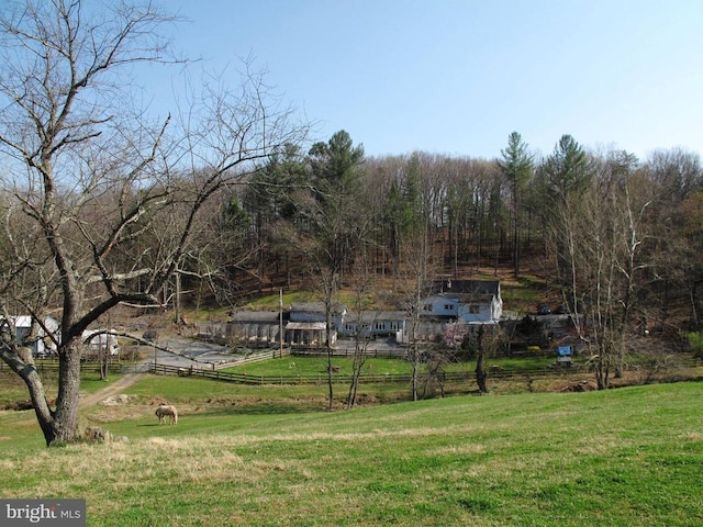 view of yard featuring fence and a rural view
