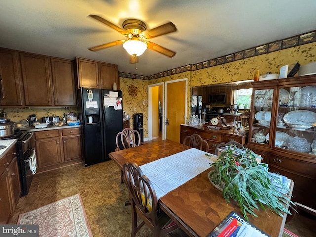 dining area featuring tile patterned floors, wallpapered walls, and ceiling fan
