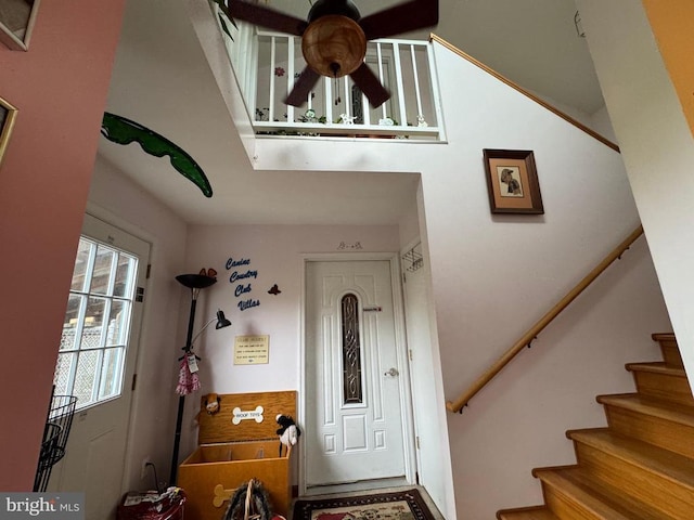 entrance foyer with stairs and ceiling fan