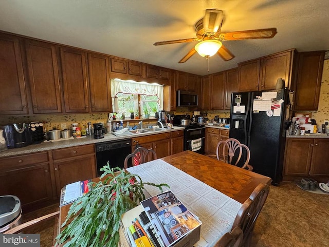 kitchen featuring light countertops, black appliances, brown cabinetry, ceiling fan, and a sink