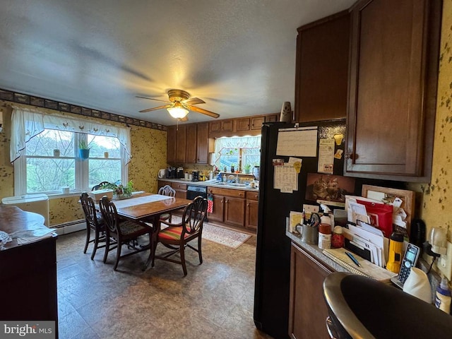 kitchen with black dishwasher, a sink, a ceiling fan, wallpapered walls, and tile patterned floors