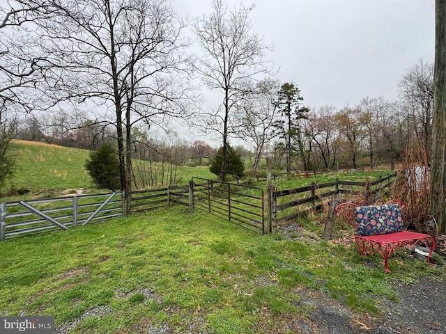 view of yard featuring fence and a rural view