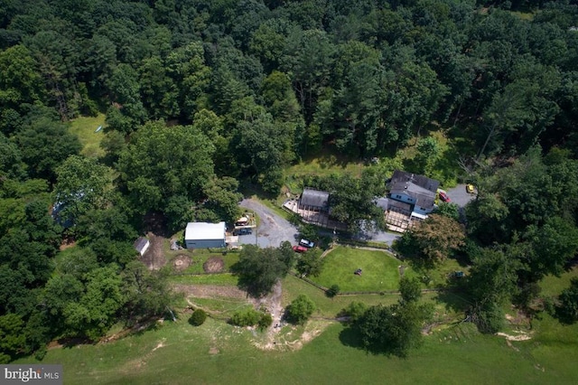 drone / aerial view with a wooded view