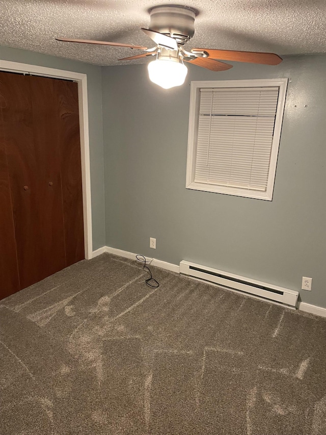 unfurnished bedroom featuring baseboard heating, ceiling fan, carpet, and a textured ceiling