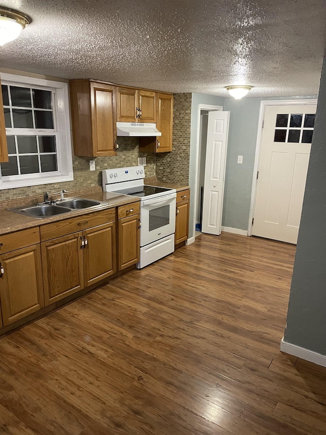 kitchen featuring sink, backsplash, white electric stove, and dark hardwood / wood-style floors