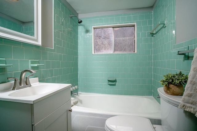 full bathroom with tile walls, vanity, tiled shower / bath, decorative backsplash, and toilet