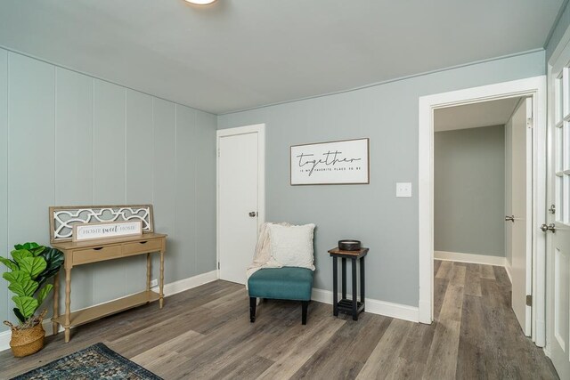 sitting room with wood-type flooring