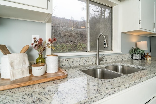 details with light stone countertops and sink