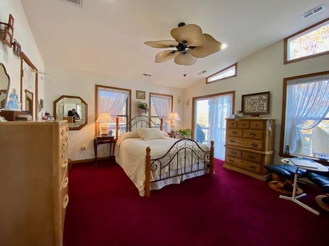 carpeted bedroom with lofted ceiling and ceiling fan