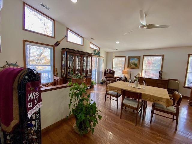 dining area with hardwood / wood-style floors and ceiling fan