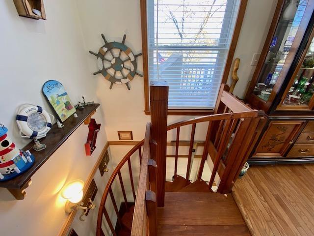 staircase with hardwood / wood-style floors