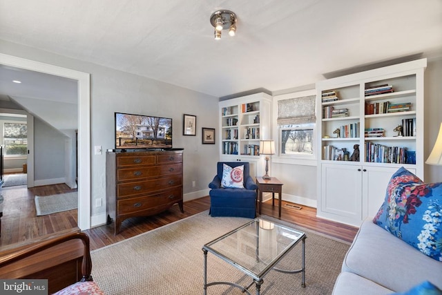 living area featuring baseboards and wood finished floors