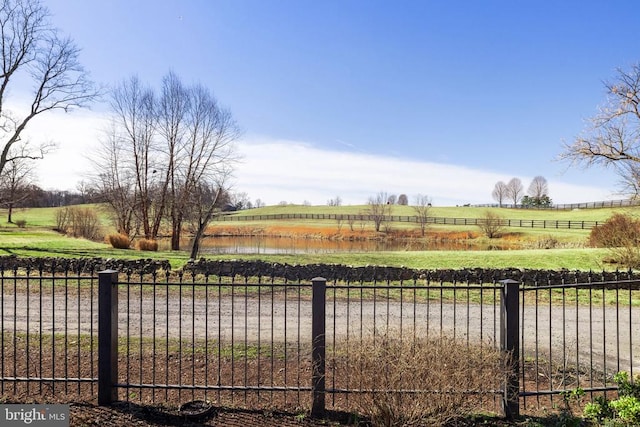 view of yard featuring a rural view and fence