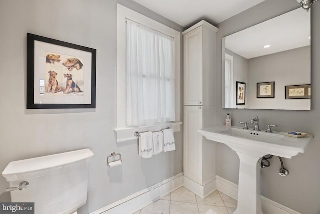 bathroom featuring tile patterned flooring, toilet, and baseboards