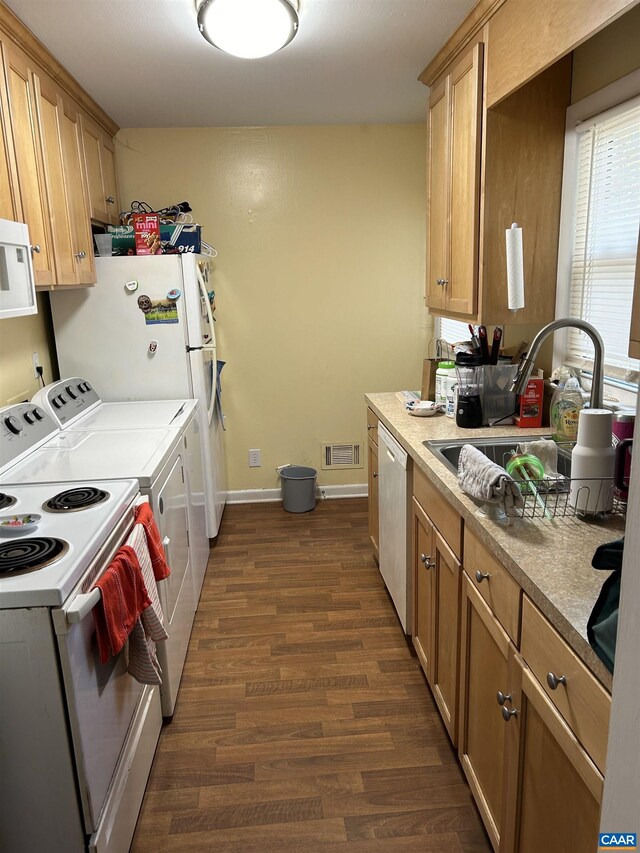 kitchen featuring dark wood-type flooring, white appliances, and sink