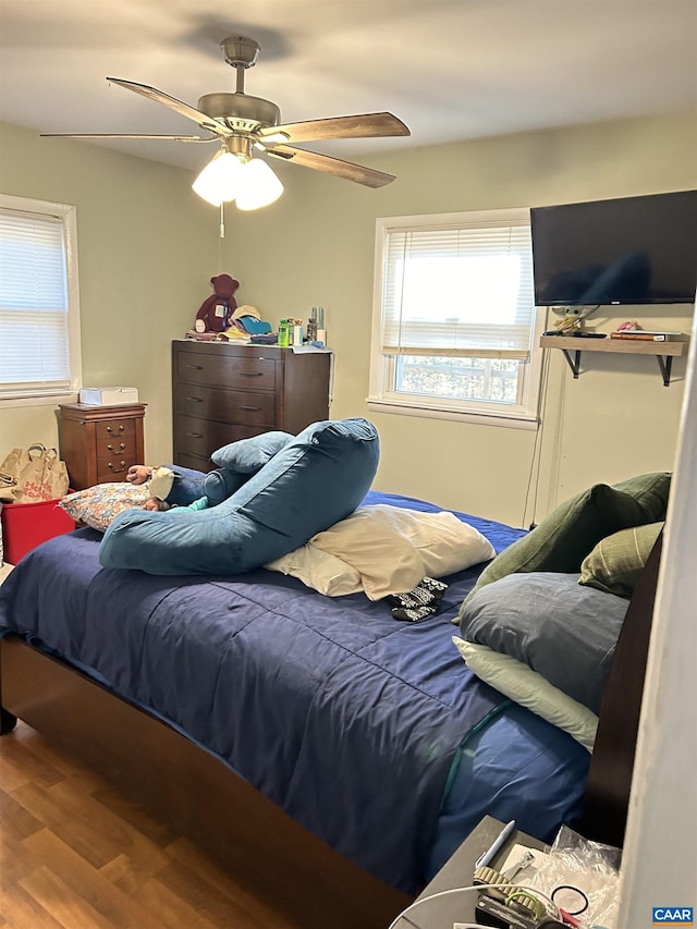 bedroom with hardwood / wood-style floors and ceiling fan