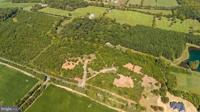 birds eye view of property featuring a rural view and a water view