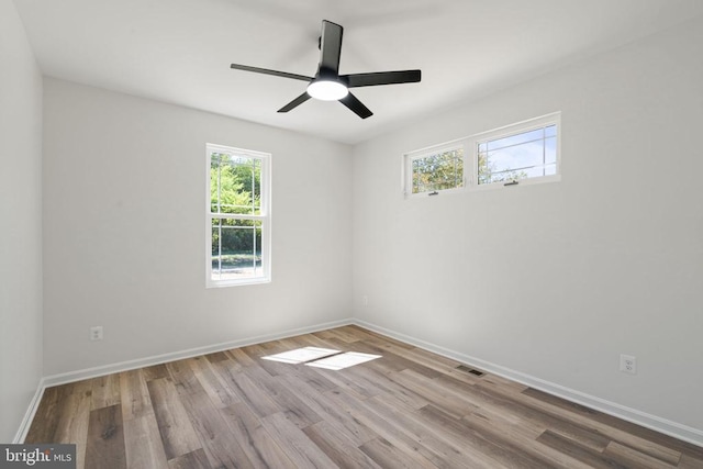 empty room featuring ceiling fan and light hardwood / wood-style floors