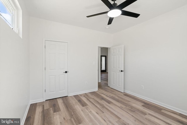 unfurnished bedroom with ceiling fan and light hardwood / wood-style flooring