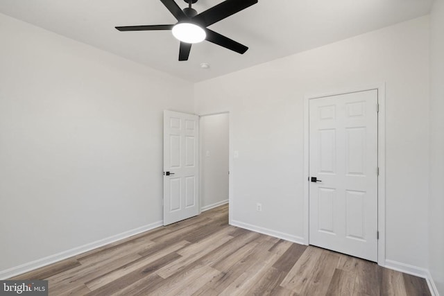 unfurnished bedroom with ceiling fan, baseboards, and wood finished floors
