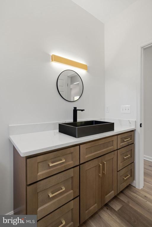 bathroom featuring hardwood / wood-style flooring and vanity