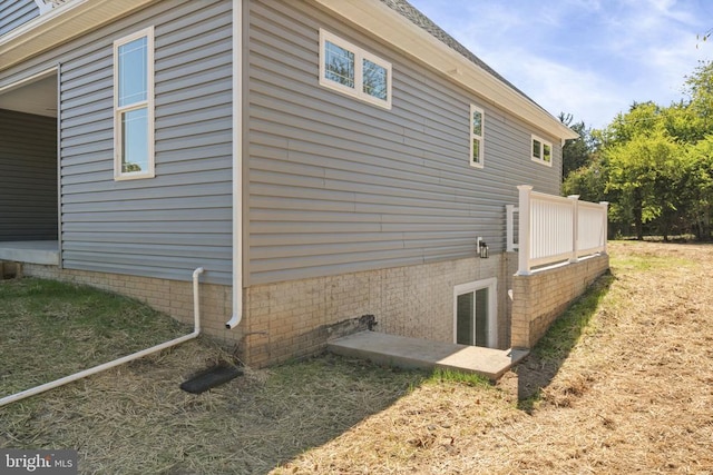 view of property exterior with a patio area