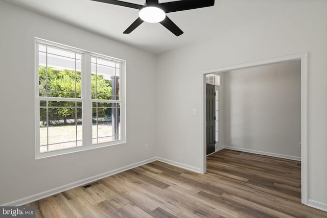 unfurnished room with hardwood / wood-style flooring and ceiling fan