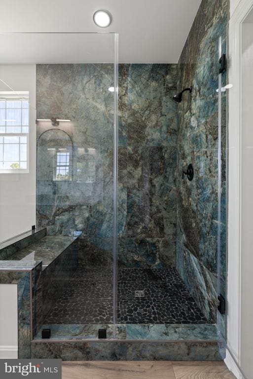 full bathroom with a marble finish shower
