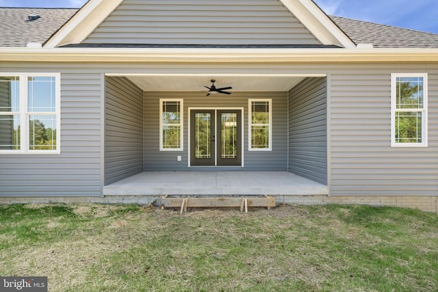 view of exterior entry featuring a patio, a yard, and ceiling fan