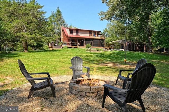 view of yard featuring a wooden deck and an outdoor fire pit