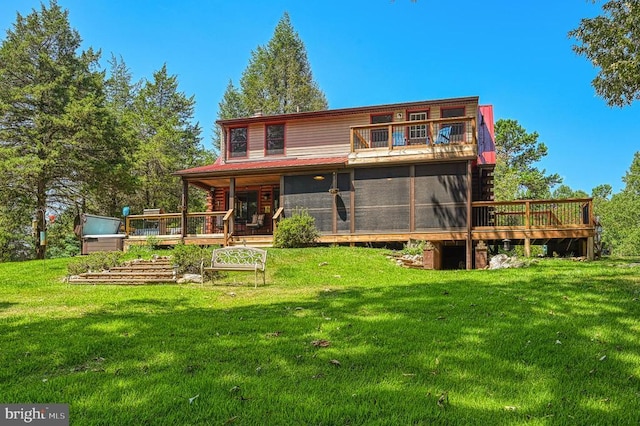 rear view of property featuring a lawn and a sunroom