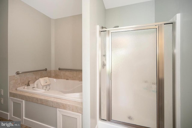 bathroom with a garden tub and a shower stall