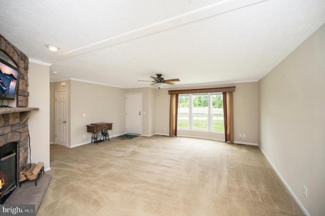 unfurnished living room with light carpet, baseboards, ornamental molding, and a stone fireplace