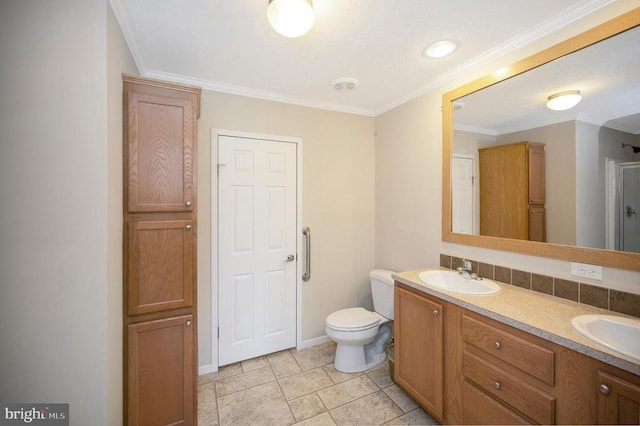 full bathroom with toilet, double vanity, ornamental molding, and a sink