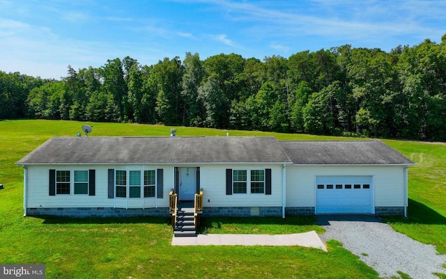 ranch-style home featuring an attached garage, driveway, and a front yard