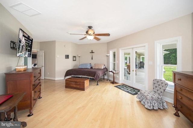 bedroom featuring access to exterior, french doors, light wood-style floors, a ceiling fan, and baseboards