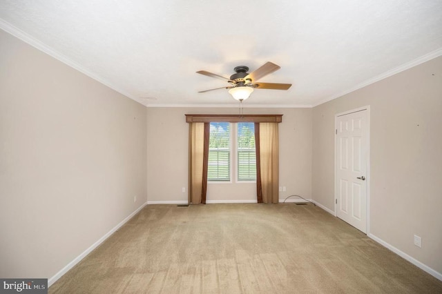 unfurnished room with crown molding, light colored carpet, and baseboards