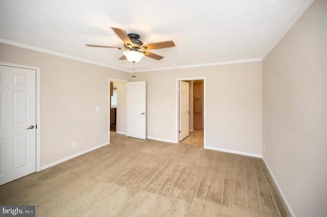 unfurnished bedroom with ornamental molding, light colored carpet, connected bathroom, and baseboards