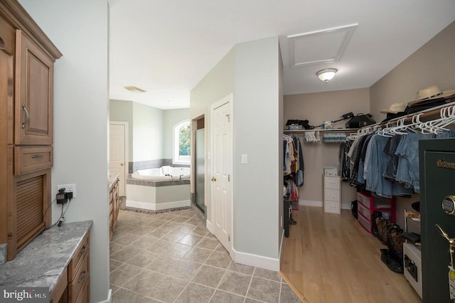 interior space with light tile patterned floors and attic access