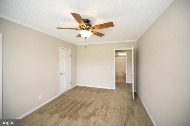 unfurnished bedroom with ornamental molding, light carpet, a textured ceiling, and baseboards