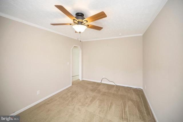 unfurnished room with arched walkways, ornamental molding, a textured ceiling, and baseboards