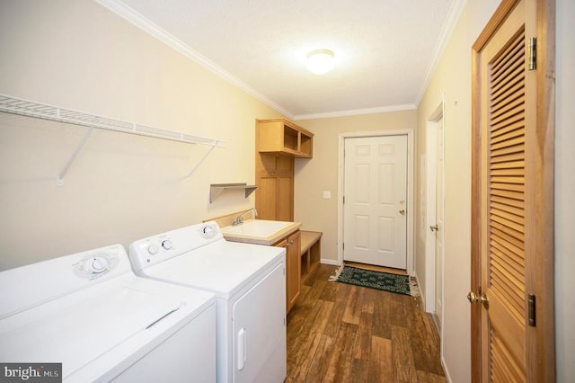 laundry room with laundry area, dark wood finished floors, ornamental molding, separate washer and dryer, and a sink